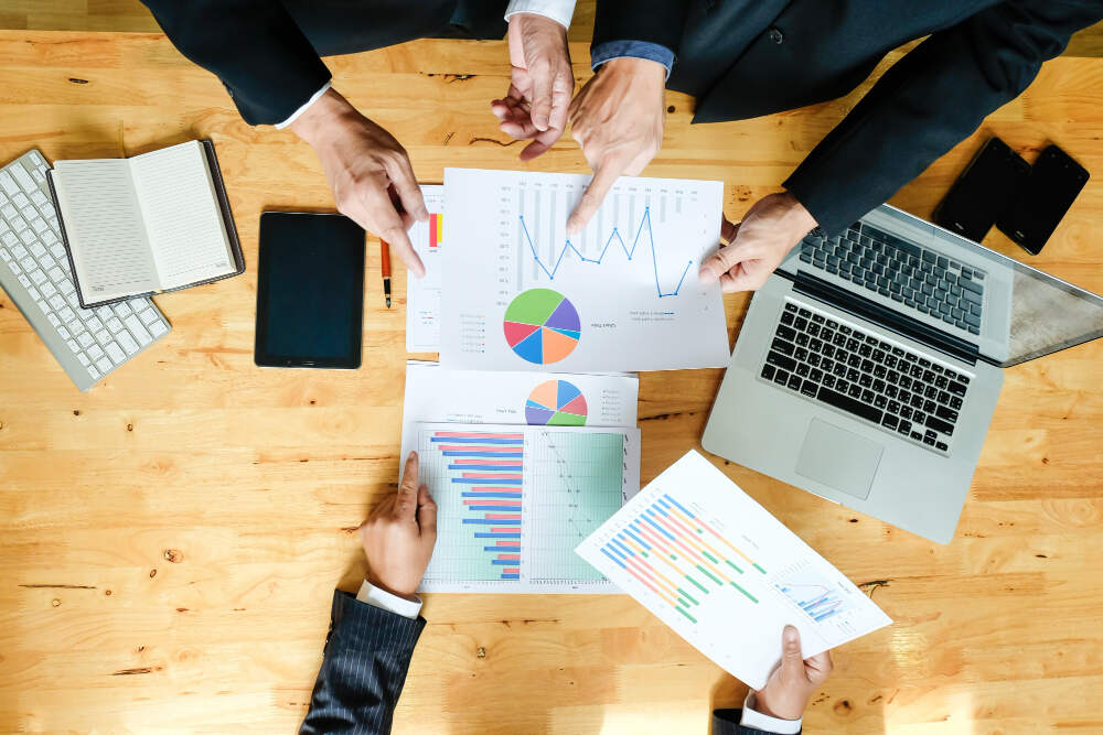 A business team working on a new business plan with a computer